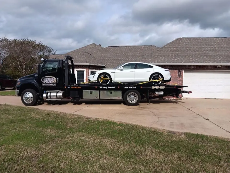 White Porsche transported on a Sadler's Towing flatbed